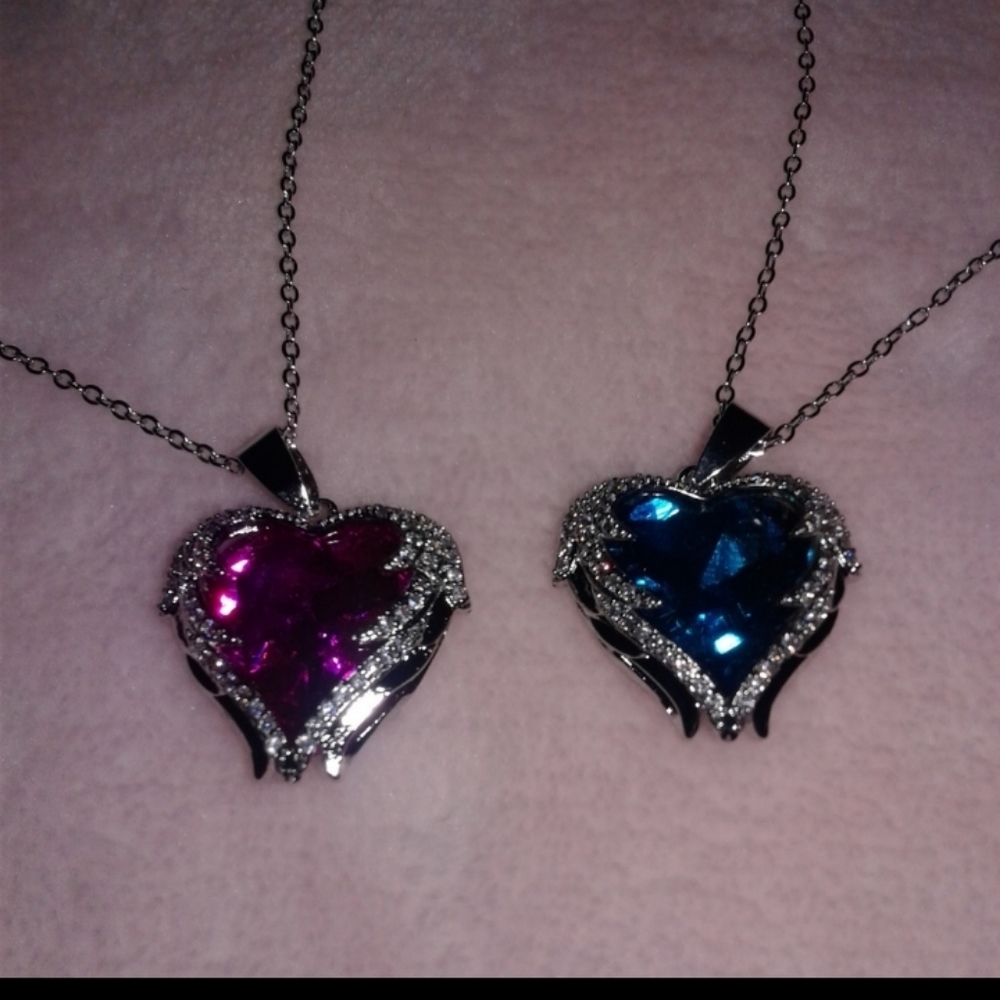 Set of 2 heart shaped costume jewelry and chain.